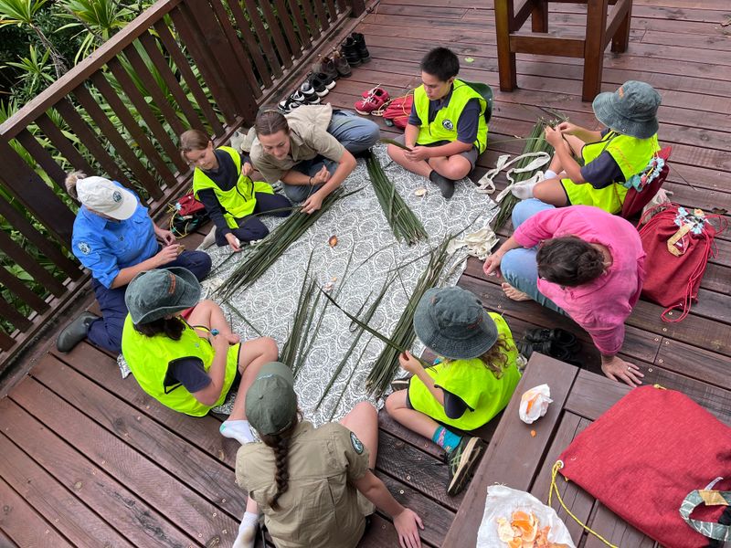 Junior Rangers and facilitators preparing the Niau midribs.